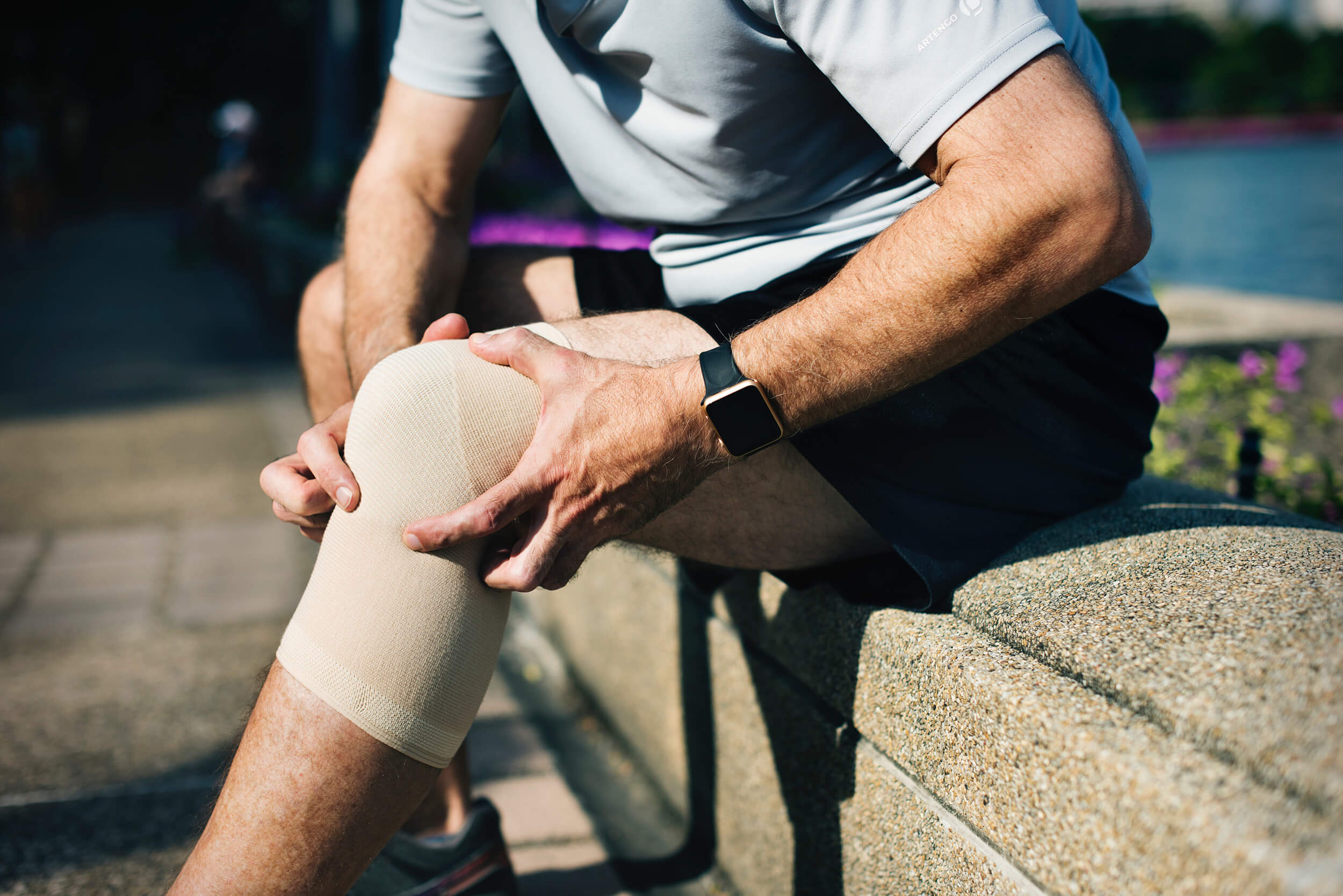Man Holding Injured Knee